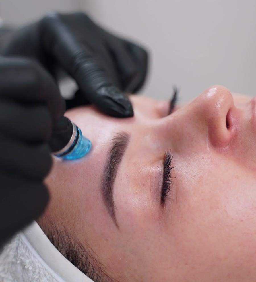 Esthetician performing an advanced facial